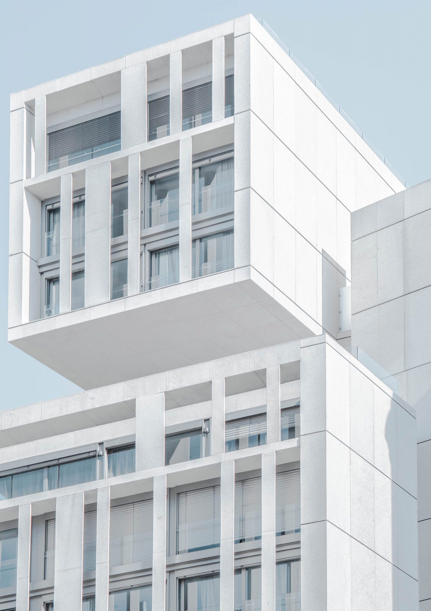 white modern cement building under blue sky
